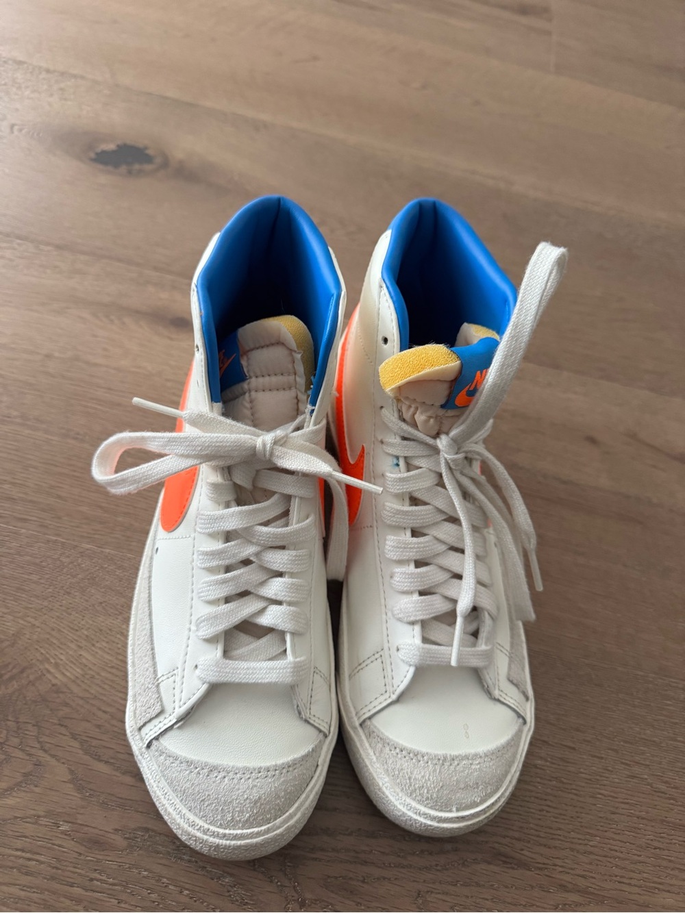 Nike White High-Top Sneakers with Orange Swoosh and Blue Lining